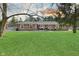 Expansive backyard featuring a well-maintained lawn and a charming brick house at sunset at 3301 Timberbrook Ct, Danville, IN 46122