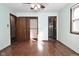 Spacious bedroom with wood floors, multiple doors, and ceiling fan at 3301 Timberbrook Ct, Danville, IN 46122