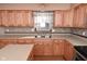 Kitchen features double sink, wood cabinets, and tile backsplash at 3301 Timberbrook Ct, Danville, IN 46122