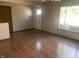 Living room with hardwood floors, a front door, a window, and natural lighting at 3301 Timberbrook Ct, Danville, IN 46122
