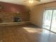 Spacious living room featuring a brick fireplace, hardwood floors, and sliding glass doors at 3301 Timberbrook Ct, Danville, IN 46122