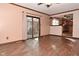 Living room with kitchen view, laminate floors, and sliding glass doors at 3301 Timberbrook Ct, Danville, IN 46122