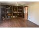 Inviting living room with hardwood floors, custom built-in bookshelves, and a ceiling fan at 3301 Timberbrook Ct, Danville, IN 46122