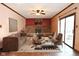 Inviting living room with a brick fireplace, neutral furniture, and sliding glass doors at 3301 Timberbrook Ct, Danville, IN 46122