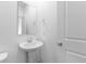 Cozy powder room with modern fixtures and pedestal sink at 349 N Post Oak Dr, Mooresville, IN 46158