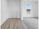 Bright entryway featuring wood-style flooring, a white front door, and a view into the carpeted living room at 349 N Post Oak Dr, Mooresville, IN 46158