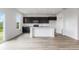 Bright kitchen featuring stainless appliances, a white island, and dark cabinets with marble countertops at 349 N Post Oak Dr, Mooresville, IN 46158