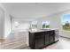 Bright, open kitchen with stainless steel appliances and hardwood floors at 349 N Post Oak Dr, Mooresville, IN 46158