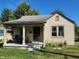 Tan colored house with front porch and yard at 3611 N Sherman Dr, Indianapolis, IN 46218