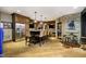 Basement bar features wood cabinets, stone accent wall, barstool seating, and a stainless steel refrigerator at 5030 Nightshade Ln, Noblesville, IN 46062