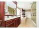 Bathroom featuring vanity with cherry cabinets and a tiled shower at 5030 Nightshade Ln, Noblesville, IN 46062