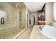 Beautiful bathroom featuring large tile shower with bench and soaking tub at 5030 Nightshade Ln, Noblesville, IN 46062