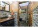 Stylish half bathroom with modern fixtures, stone tiles, and decorative wood accents at 5030 Nightshade Ln, Noblesville, IN 46062