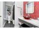 Stylish bathroom with a glass bowl sink, red mosaic tile accent wall, and glass shelving at 5030 Nightshade Ln, Noblesville, IN 46062
