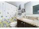 Bathroom with a floral curtain, granite counter, framed mirror, and towel rack at 5030 Nightshade Ln, Noblesville, IN 46062