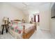 Bedroom features a bed with a colorful quilt, wooden furniture, and soft lighting, creating a warm and inviting space at 5030 Nightshade Ln, Noblesville, IN 46062