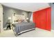 Bedroom with a rustic headboard, modern lamps, and a red sliding barn door at 5030 Nightshade Ln, Noblesville, IN 46062