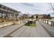 An outdoor deck with a table, chairs, and a view of the greenhouse and home at 5030 Nightshade Ln, Noblesville, IN 46062