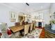 Dining area with hardwood floors, a rustic wooden table, and decorative cabinet at 5030 Nightshade Ln, Noblesville, IN 46062