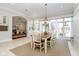 Bright dining room with large windows, a classic table setting, and hardwood floors at 5030 Nightshade Ln, Noblesville, IN 46062