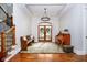 Elegant foyer with hardwood floors, staircase, chandelier, and wooden accents at 5030 Nightshade Ln, Noblesville, IN 46062