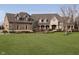 Beautiful brick home with a large front yard, mature trees, and arched entryway at 5030 Nightshade Ln, Noblesville, IN 46062