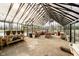 Interior of spacious greenhouse featuring high ceilings, potting benches, and ample natural light at 5030 Nightshade Ln, Noblesville, IN 46062