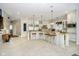 Open concept kitchen with granite island, white cabinetry, stainless steel appliances, and bar stool seating at 5030 Nightshade Ln, Noblesville, IN 46062