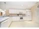 Bright kitchen features white cabinets, appliances, and ample counter space for easy food preparation and organization at 5030 Nightshade Ln, Noblesville, IN 46062