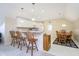 Eat-in kitchen with breakfast bar seating, pendant lighting, and a wooden dining table set for comfortable dining at 5030 Nightshade Ln, Noblesville, IN 46062