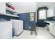 Charming laundry room featuring white cabinets, a laundry sink, and front load machines at 5030 Nightshade Ln, Noblesville, IN 46062