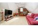 Upstairs living room features a tv, desk, bookshelves, and a red sofa at 5030 Nightshade Ln, Noblesville, IN 46062