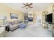 Comfortable living room featuring a fireplace, neutral decor, and an adjoining room at 5030 Nightshade Ln, Noblesville, IN 46062