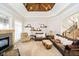 Inviting living room featuring a fireplace, a vaulted ceiling, and plush seating at 5030 Nightshade Ln, Noblesville, IN 46062