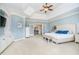 Bright main bedroom with a tray ceiling, sitting area, and double french doors leading to another room at 5030 Nightshade Ln, Noblesville, IN 46062
