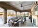 Covered patio with brick archways is designed for comfort with outdoor furniture and views of the snowy yard at 5030 Nightshade Ln, Noblesville, IN 46062