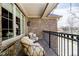 A covered patio has seating and a view of the backyard and winter trees beyond at 5030 Nightshade Ln, Noblesville, IN 46062