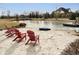 Relaxing sandy beach with lakeside access, Adirondack chairs, and views of house at 5030 Nightshade Ln, Noblesville, IN 46062