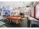 Spacious recreation room featuring a pool table, shuffle board, and sports decor at 5030 Nightshade Ln, Noblesville, IN 46062