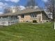 Brick home backyard featuring a large, well-maintained lawn and spacious deck at 5299 Carnoustie Cir, Avon, IN 46123