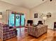 Living room with hardwood floors, vaulted ceiling, and access to patio at 5299 Carnoustie Cir, Avon, IN 46123