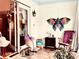 Bright sunroom with rocking chair, butterfly art, and access to backyard at 5299 Carnoustie Cir, Avon, IN 46123