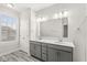 Bathroom with dual sink vanity, white counters, and trendy flooring at 537 Steinbeck Pl, Carmel, IN 46032