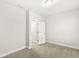 Well-lit bedroom with neutral carpet flooring and a view to the double door closet at 537 Steinbeck Pl, Carmel, IN 46032