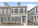 Charming gray two-story home with black shutters, a welcoming blue door, and a wrought iron fence at 537 Steinbeck Pl, Carmel, IN 46032