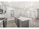 A well-lit kitchen with modern island, stainless steel appliances, and an open view of the entryway at 537 Steinbeck Pl, Carmel, IN 46032