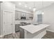Stylish kitchen boasts an island with bar seating, stainless steel appliances and subway tile backsplash at 537 Steinbeck Pl, Carmel, IN 46032