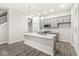 Modern kitchen featuring a large island with quartz countertops and stainless steel appliances at 537 Steinbeck Pl, Carmel, IN 46032