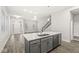 Open floor plan with a kitchen island, stainless steel dishwasher, and a view of the living area at 537 Steinbeck Pl, Carmel, IN 46032