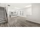 Open living area with wood floors and a staircase that leads to the kitchen with a breakfast bar at 537 Steinbeck Pl, Carmel, IN 46032